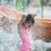 A girl stands under water at Blue Heron Bay at Independence Lake County Park on Saturday, July 6. Daniel Brenner I AnnArbor.com